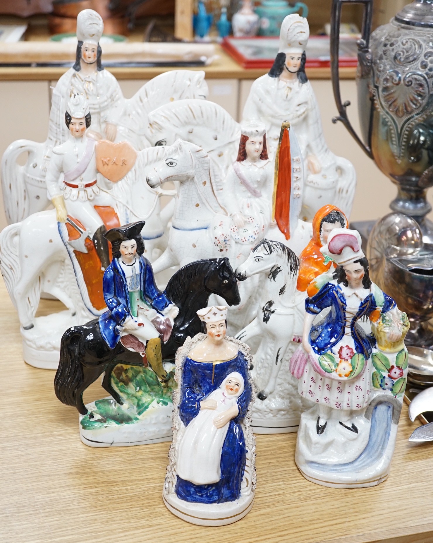 Two pairs of Staffordshire flat backs of figures on horseback, two others, a mother and child and flower seller